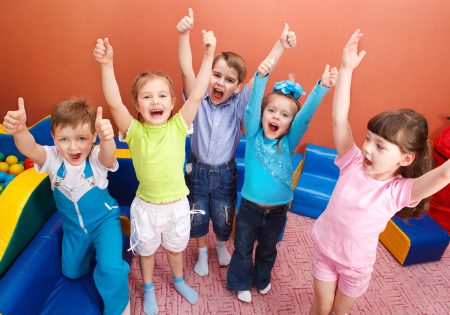 Group of shouting kids with hands up